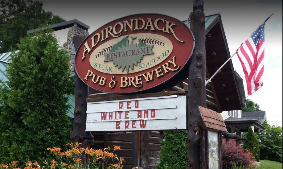 Image of the Adirondack Pub & Brewery sign out in front of their restaurant.