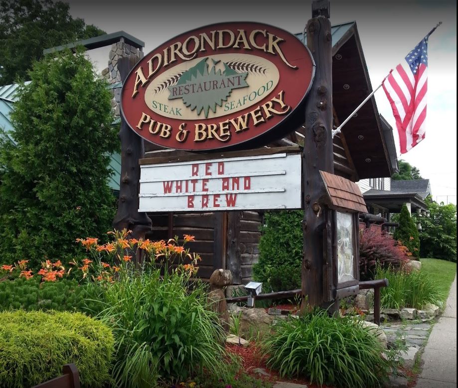 Image of the Adirondack Pub & Brewery sign out in front of their restaurant.