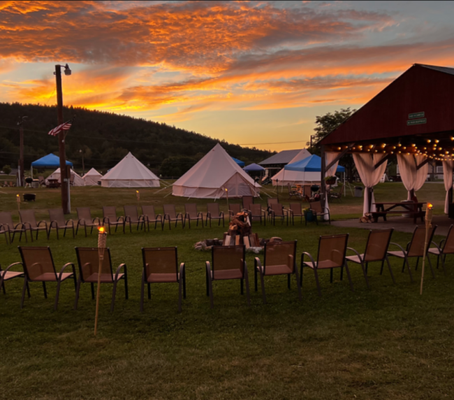 Communal campground area at ADK Safari, chairs and tents