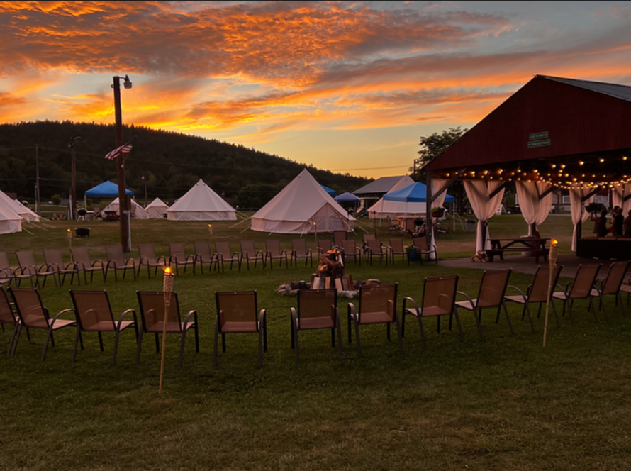 Communal campground area at ADK Safari, chairs and tents