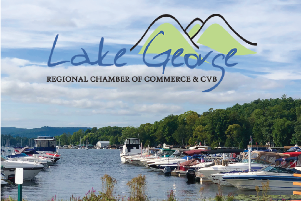 Lake George Chamber Logo over lake with boats