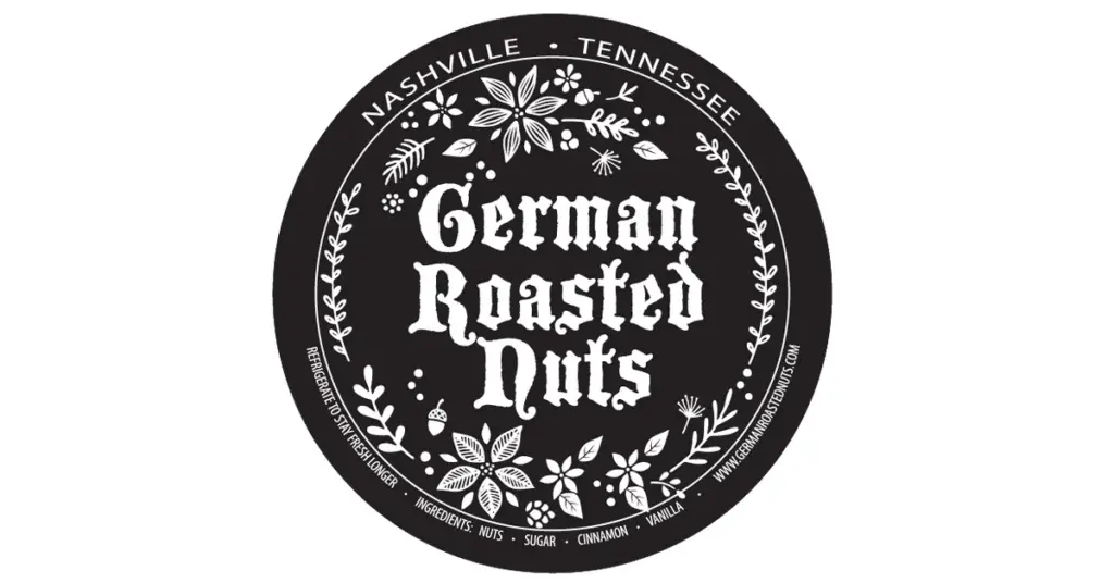 Circular black label that says 'German Roasted Nuts' with a decorative white floral border and 'Nashville • Tennessee' around the edge